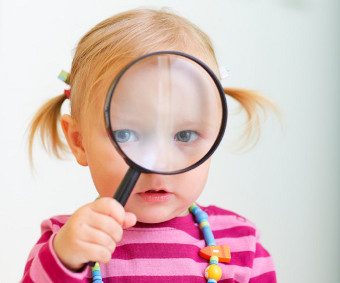 Kid with magnifying glass